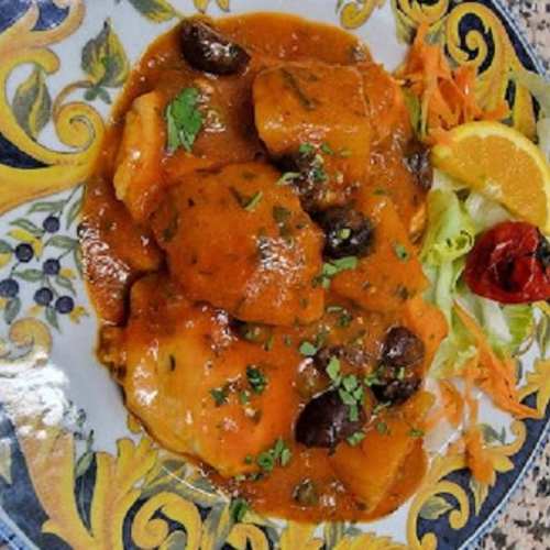 Seafood speciality in a sauce with olives and citrus