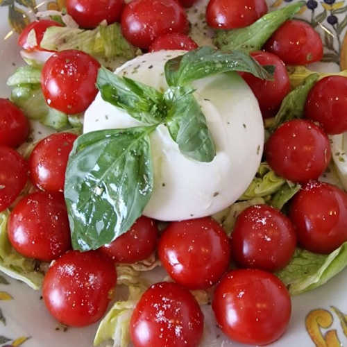 Burrata, cherry tomatoes and basil on Sicilian ceramics