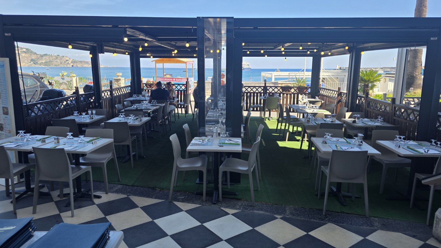 Terrace tables overlooking the sea in Giardini Naxos